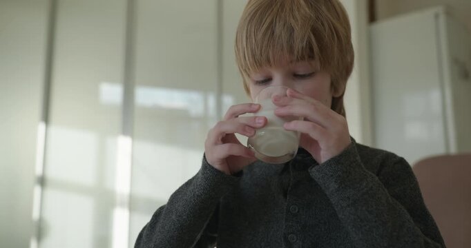 Kid Boy Drink Milk in Kitchen. 4K 10-bit