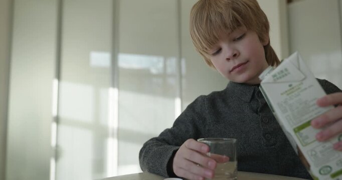 Kid Boy Drink Milk in Kitchen. 4K 10-bit