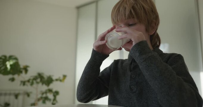 Kid Boy Drink Milk in Kitchen. 4K 10-bit
