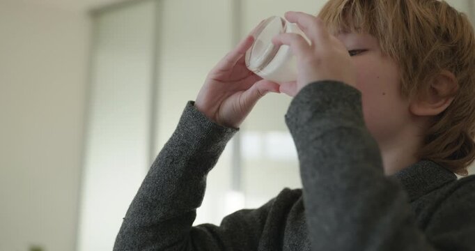 Kid Boy Drink Milk in Kitchen. 4K 10-bit