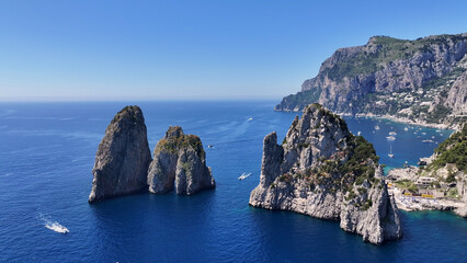 Obraz premium Faraglioni Rocks In Capri Naples Italy. Turquoise Ocean Waves Gently Crashing On Tropical Beach. Coast Clouds Seaside Summertime. Outdoors Seaside Scenic Coastline. Capri Naples.
