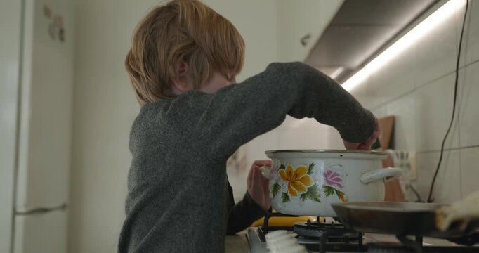 Kid Boy Prepares Rice for Meal in Kitchen. 4K 10-bit