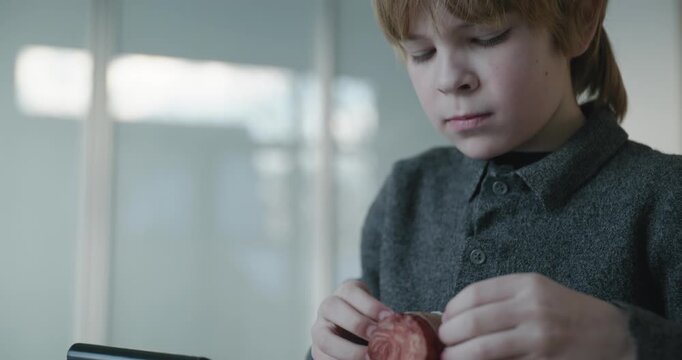 Kid Boy Cut Sausage Using Knife. Eating Breakfast Lunch in Kitchen. 4K 10-bit