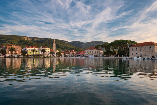 Picturesque waterfront of Jelsa town with reflections at sunrise, Hvar island