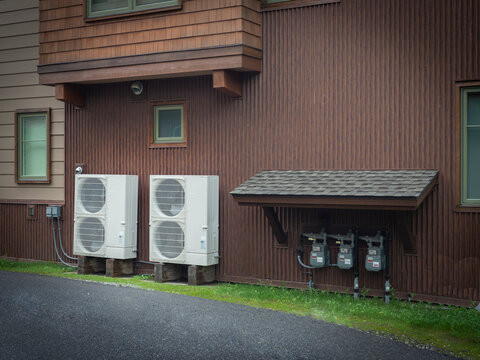 Heat pumps outside a house in a modern setting