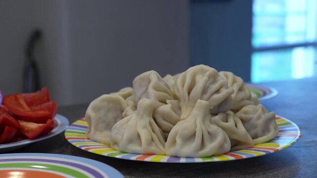 4K footage of steaming hot traditional khinkali on a plate