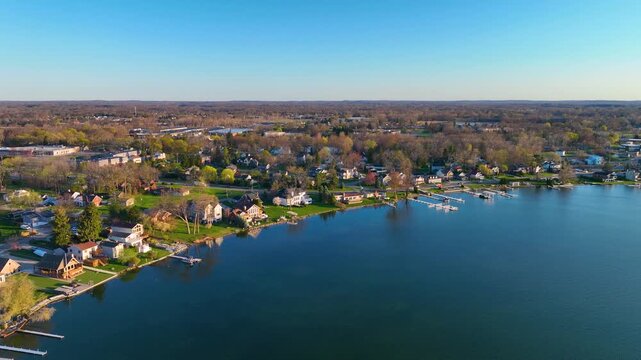 Waterfront residential houses aerial view in the morning on Walled Lake in city of Walled Lake, Michigan MI, USA. 