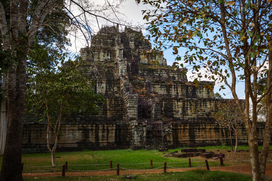 View of the ancient Prasat Thom stepped pyramid temple rising above the surrounding forest canopy in Koh Ker, Siem Reap Province, Cambodia.