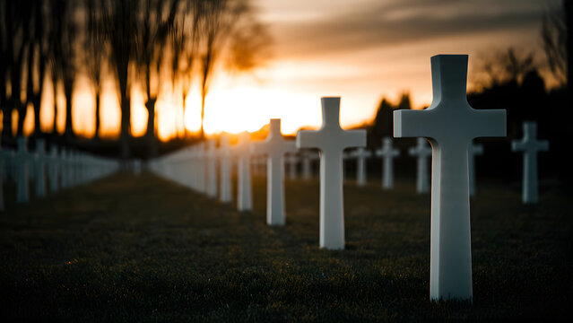 Rows of stone grave markers stand in a military burial field during a golden sunset reflecting light upon the solemn graveyard landscape representing sacrifice remembrance and eternal peace for