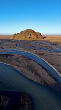 Vertical Push Reveal Drone video of Stora Dimon Mountain in Iceland in a sunny day at sunrise
