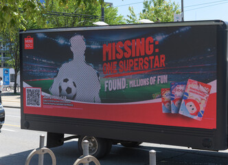 Obraz premium mobile digital billboards or LED billboard trucks with ad for MINISO and soccer, Toronto