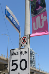 Obraz premium traffic signs on Lake Shore Blvd E including a pole-mounted projecting banner for The Lassonde Art Trail, Toronto