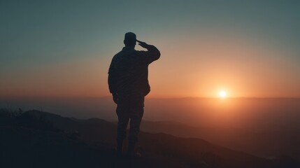 Obraz premium Soldier silhouette saluting sunset