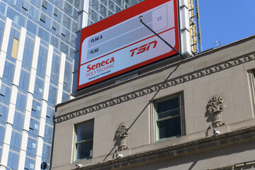 Obraz premium rooftop electronic billboard for Seneca Polytechnic and TSN atop the historic Dominion Bank Building by John M Lyle, 1930, Gerrard St W and Yonge St, Toronto