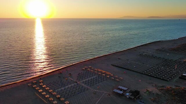 Aerial Drone Shot of Stunning Sunset Over Beach and Calm Sea
