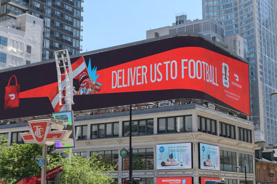 rooftop spectacular with DoorDash advertising (FIFA World Cup 2026 marketing campaign) atop historic building at 279 Yonge St (at Dundas Square), Toronto