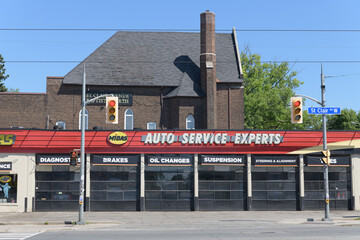 Obraz premium wide view of Midas, an auto repair shop, located at 624 St Clair Av W, Toronto (behind: St Clair Avenue Baptist Church)