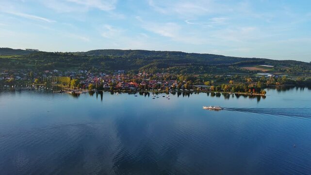 Aerial View of Serene Lake Town with Boat Cruising on Calm Water