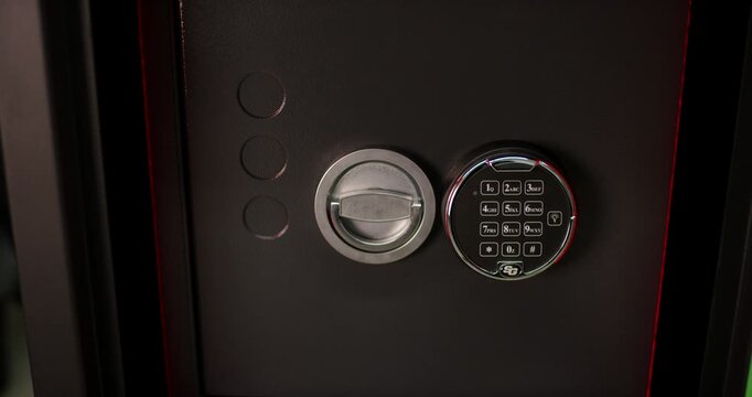 Electronic safe lock mechanism with numeric keypad and round handle dial on a heavy secure door