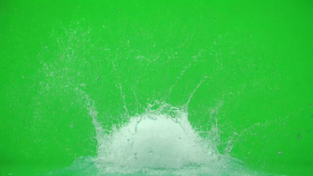 Large water splash isolated on green screen background liquid drop droplet