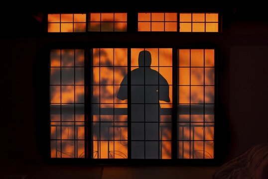Shadows of a man in kimono, on the balcony behind sliding shoji doors in a traditional Japanese house, Yamanouchi, Nagano, Japan