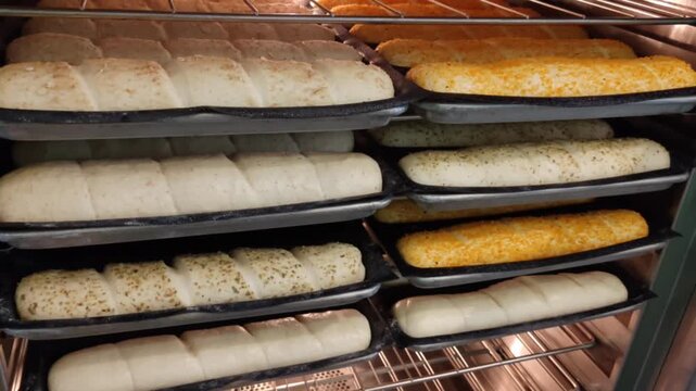 Submarine sandwich dough loaves undergoing a controlled proofing process inside an industrial kitchen cabinet showing active yeast fermentation for fast food franchise baking tutorial advertising.