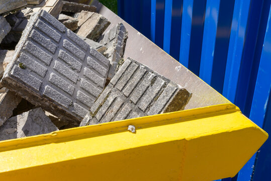 Yellow industrial container full of debris The Concept of Recycling