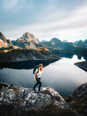 Obraz premium Woman hiking solo in Norway explore Lofoten islands travel active healthy lifestyle summer vacations adventure tour outdoor, tourist girl enjoying mountains and Solbjornvatnet lake view eco tourism