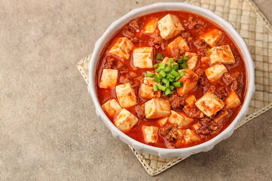 Szechuan mapo tofu in ceramic bowl for spicy Chinese cuisine 
