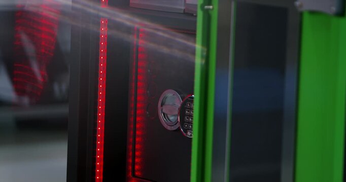 Closed black high security safe door featuring a electronic digital keypad lock and turning handle