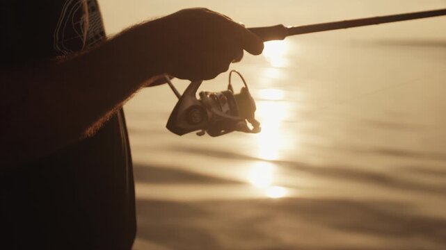 Angler stands in the boat and fishing on the lake