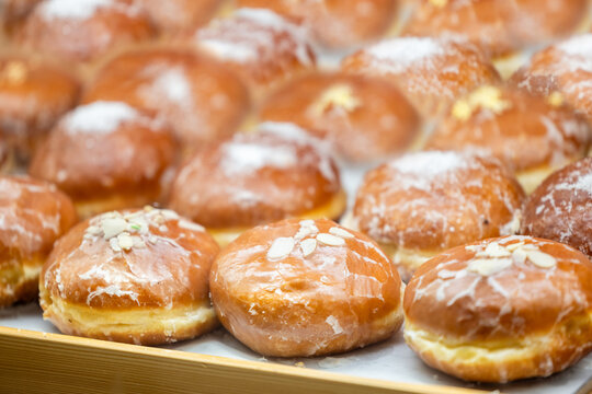 Traditional donuts with almonds and powdered sugar