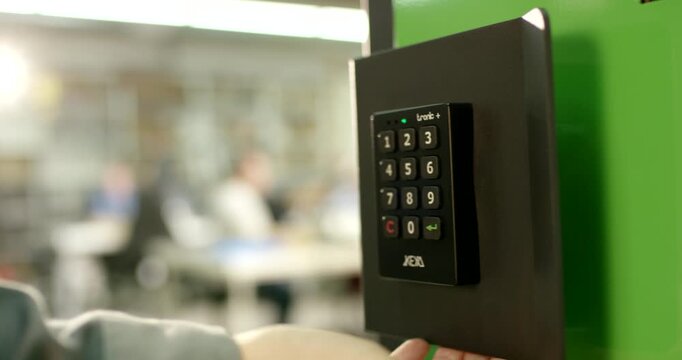 Close up view of an electronic safe lock with a round dial handle and numeric code keypad