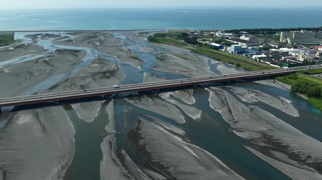 Aerial drone footage of Abekawa River mouth braided channels flowing into Suruga Bay, Shizuoka