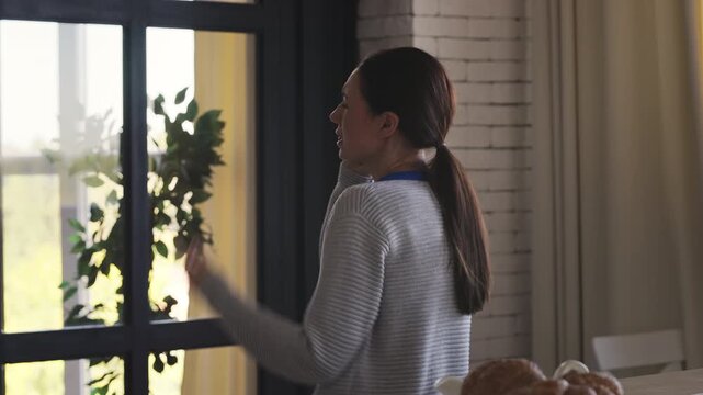Middle-aged woman talking on a smartphone at home after receiving bad news