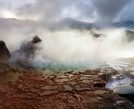 Dawn at the geysers and geothermal steam vents of the El Tatio Geyser Field at 4500m 14764ft in the Atacama Desert in northern Chile - Due to the altitude temperatures at dawn can be as low as -15C