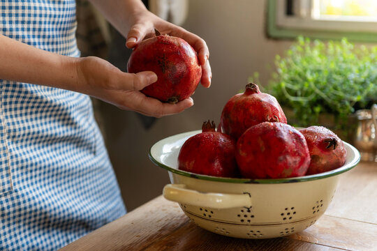 Fresh pomegranates in rustic kitchen.