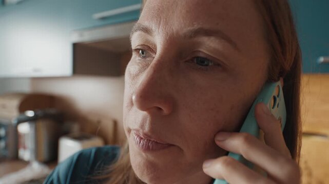 Woman talks on mobile phone in the room of an apartment. Wide angle lens with distorted face