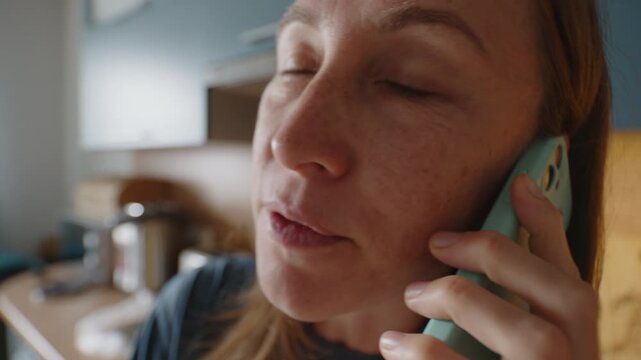 Woman talks on mobile phone in the room of an apartment. Wide angle lens with distorted face