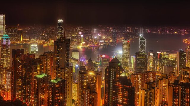 Panorama of Hong Kong, China. Spectacular night view of Victoria Harbour skyline from Victoria Peak. The Peak is the highest mountain in Hong Kong Island.