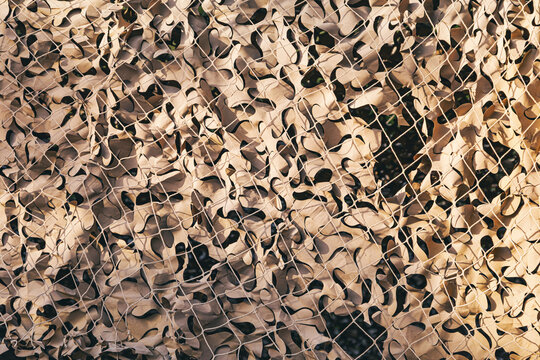 Military camouflage netting forming a protective background pattern, ideal for tactical concealment and security concepts
