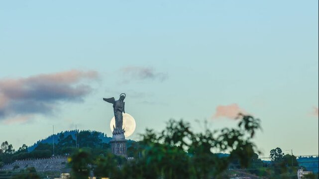 Timelapse video of the full moon setting behind the historic Virgin of El Panecillo in Quito at dawn
