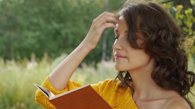 Portrait of beautiful woman holding book