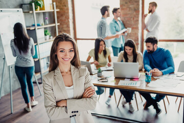 Fototapeta premium Confident businesswoman leading a creative office team in a modern startup workspace