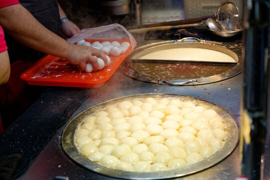 At a stall in Ningxia Night Market Taipei, the vendor sells Sweet Glutinous Rice Balls, which is hot mochi served with condensed milk and a traditional Taiwanese dessert enjoyed by locals and tourists