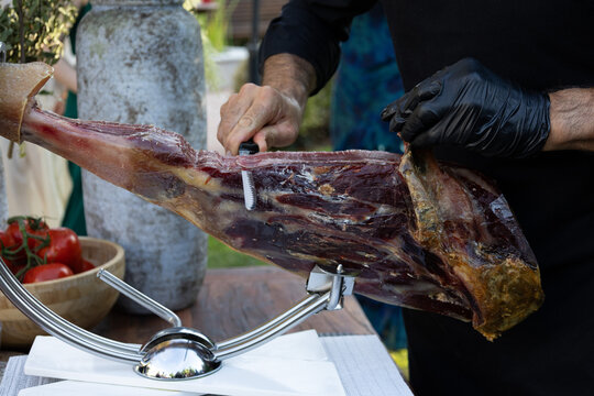Professional ham slicer carving iberian jamon leg