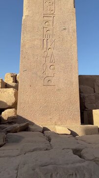 A low-angle view of Queen Hatshepsut pink granite obelisk at the Karnak Temple Complex in Luxor.
