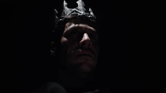 Cinematic portrait of a cruel medieval king standing in shadows of dark castle