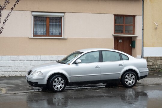 Silver Volkswagen Passat B5.5 saloon car parked on street in rain