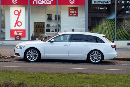 White Audi A6 Avant Type C7 executive estate car parked on street, side view